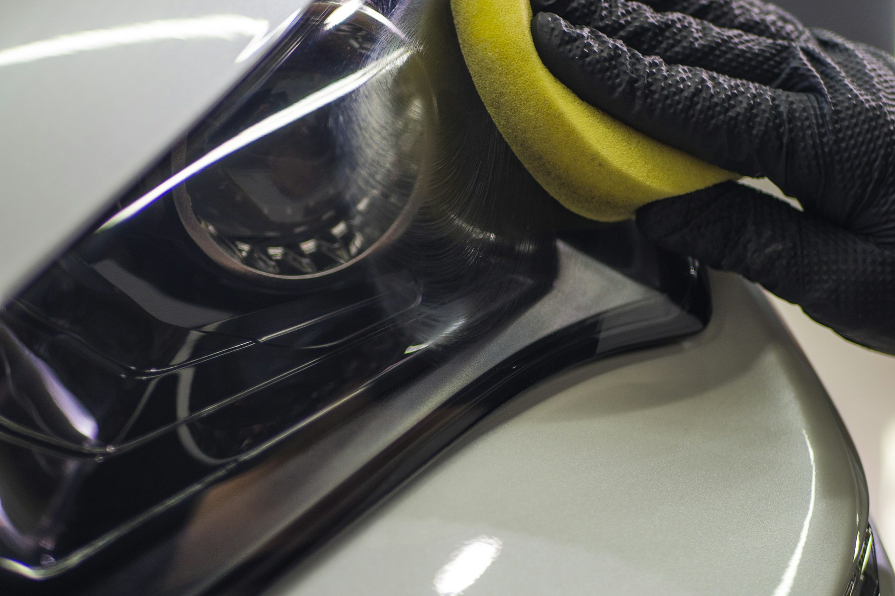 Licensed stock photo showing a hands-on car detailing process